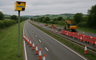 A rural dual carriage way with roadworks and speed cameras